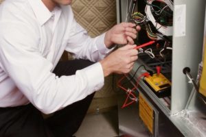 Technician repairing a furnace